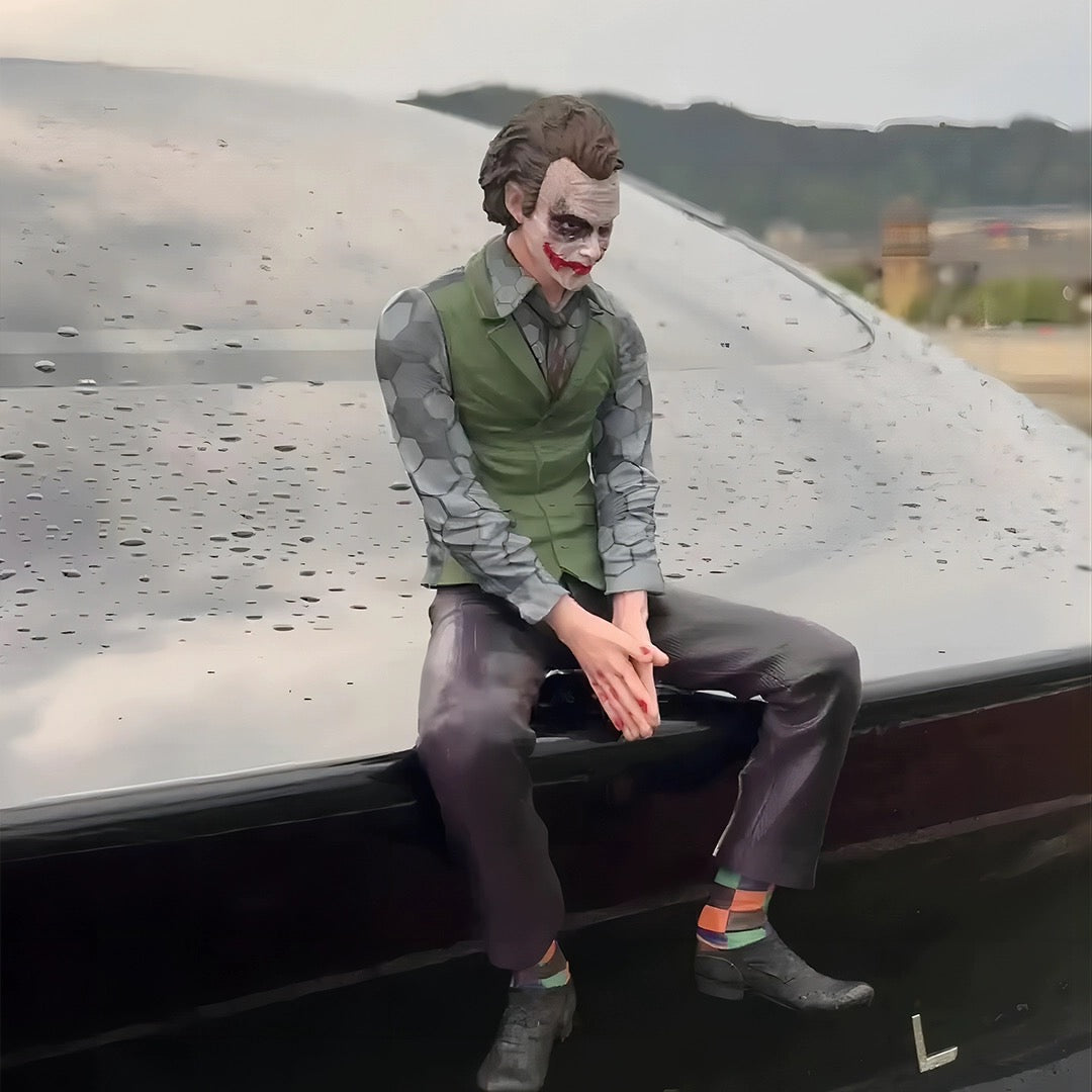 joker sitting on car